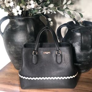 Kate Spade New York Saffiano Leather black purse with white ruffle line design.